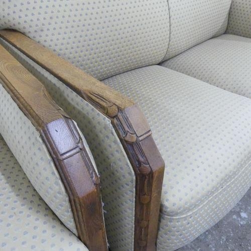 2504 - A 1930s oak and upholstered Art Deco three-piece suite, comprising a two seater sofa and two matchin... 