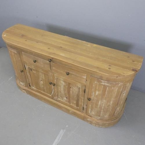 2505 - A modern pine bow-front sideboard. Width 175cm, height 86cm, depth 45cm.