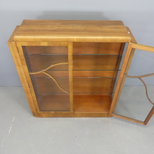 2519 - An Art Deco walnut display cabinet. with two glazed doors and two glass shelves. Width 104cm, height... 