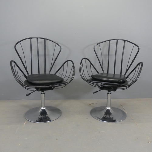 2524 - A pair of butterfly design swivel chairs, the painted tubular metal frame on chrome base with rise a... 