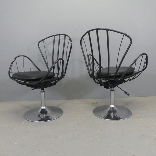 2524 - A pair of butterfly design swivel chairs, the painted tubular metal frame on chrome base with rise a... 