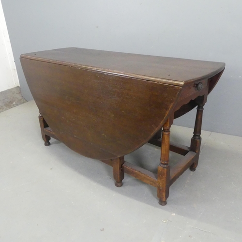 2526 - A 19th century oak oval gate-leg drop-leaf dining table, with turned legs and two end frieze drawers... 