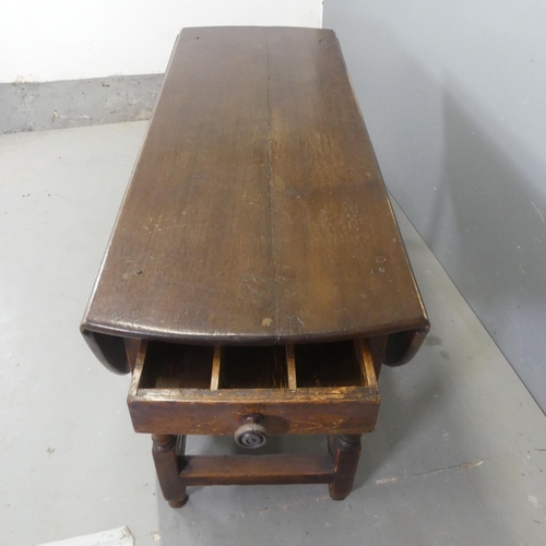 2526 - A 19th century oak oval gate-leg drop-leaf dining table, with turned legs and two end frieze drawers... 