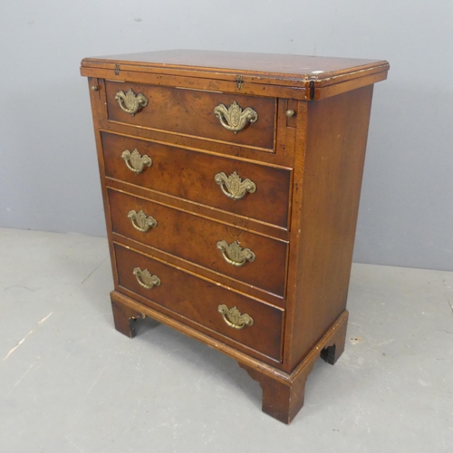 2549 - A Georgian style oak and mahogany bachelor's chest of four drawers, with walnut veneered foldover to... 