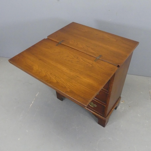 2549 - A Georgian style oak and mahogany bachelor's chest of four drawers, with walnut veneered foldover to... 