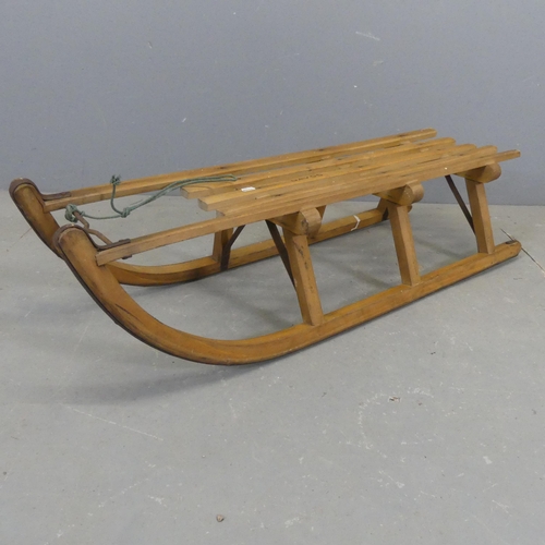 2550 - A vintage pine sledge with metal runners. Length 103cm.