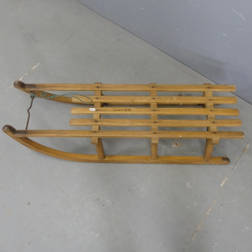 2550 - A vintage pine sledge with metal runners. Length 103cm.