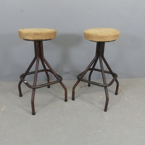 2559 - A pair of industrial machinist's style stools, with hessian upholstered seats on tubular metal base ... 