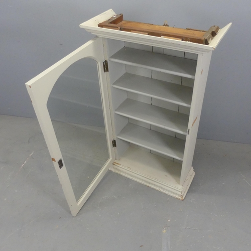 2580 - A painted pine bookcase with single glazed door. Width 73cm, height 121cm, depth 32cm.