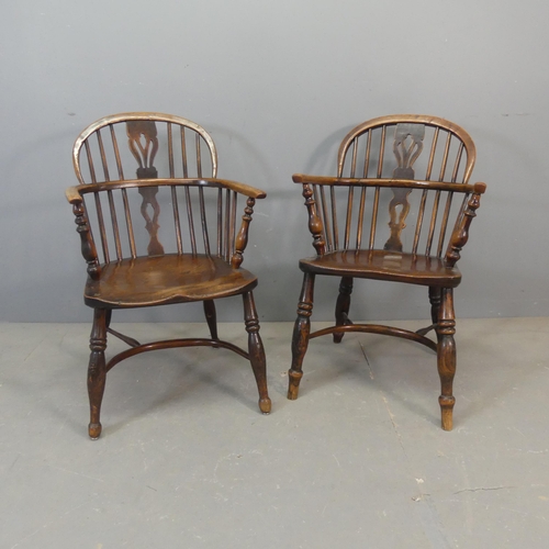 2678 - Two similar 19th century elm-seated comb-back Windsor elbow chairs with crinoline stretchers.