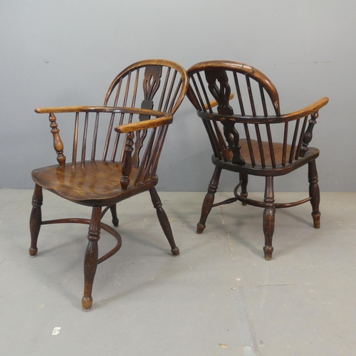 2678 - Two similar 19th century elm-seated comb-back Windsor elbow chairs with crinoline stretchers.