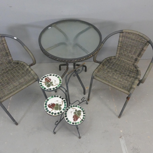 2684 - A circular glass top garden table and two matching chairs, and a painted metal folding three-tier mo... 