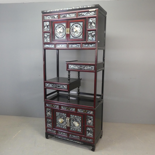 2694 - A modern Korean two-section black and red-lacquered display cabinet, with four cupboard doors, five ... 