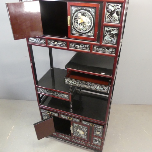 2694 - A modern Korean two-section black and red-lacquered display cabinet, with four cupboard doors, five ... 