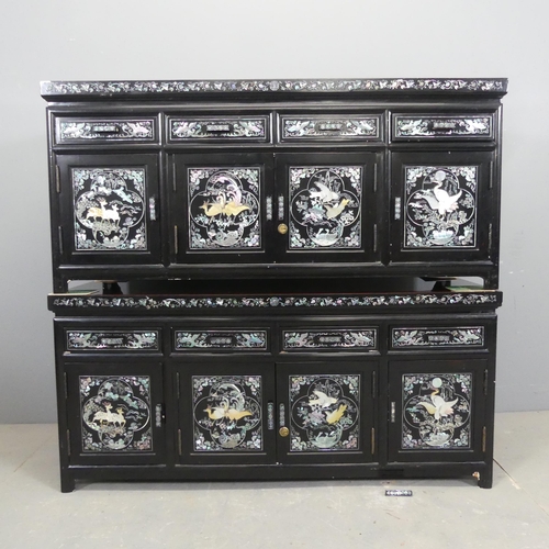 2696 - A pair of Korean black lacquered low cabinets, each with four drawers above four cupboard doors, and... 