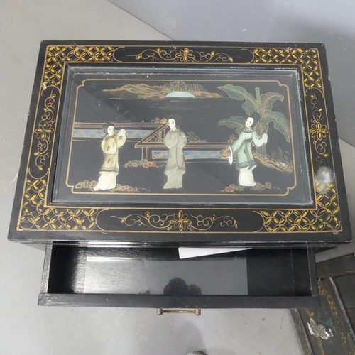 2700 - A pair of Korean black lacquered bedside cabinets, with hardstone and painted decoration. Width 51cm... 