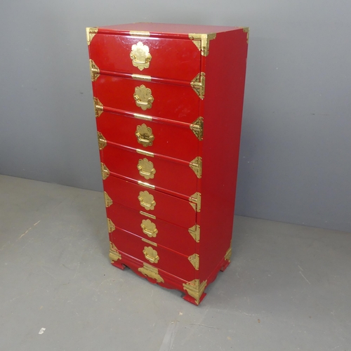 2702 - A Korean red-lacquered kiriwood Tansu chest of seven drawers, with brass mounts and pulls. Width 61c... 