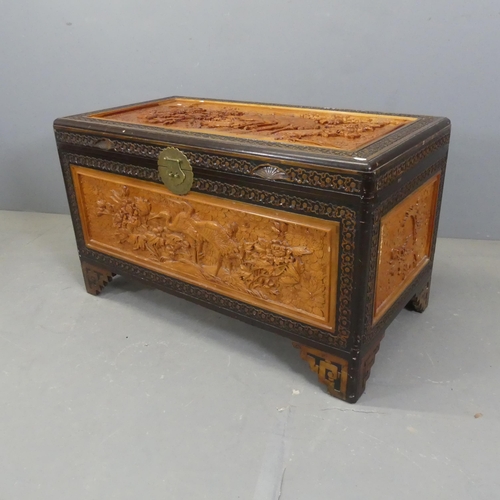 2703 - A Chinese camphorwood blanket box, with all-over carved decoration and raised on bracket feet. Width... 