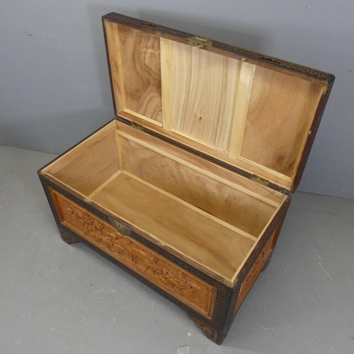 2703 - A Chinese camphorwood blanket box, with all-over carved decoration and raised on bracket feet. Width... 