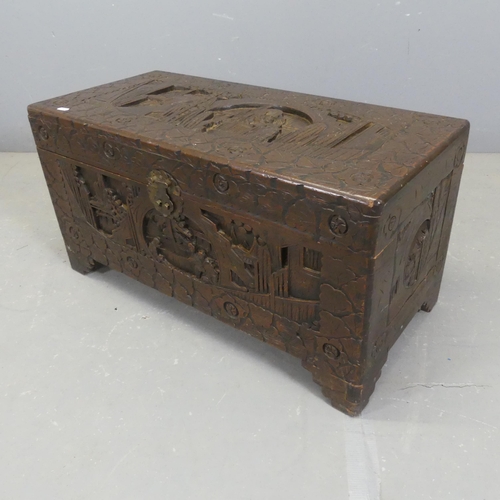 2704 - A small Chinese camphorwood blanket box with all-over carved decoration, in the manner of. Width 79c... 