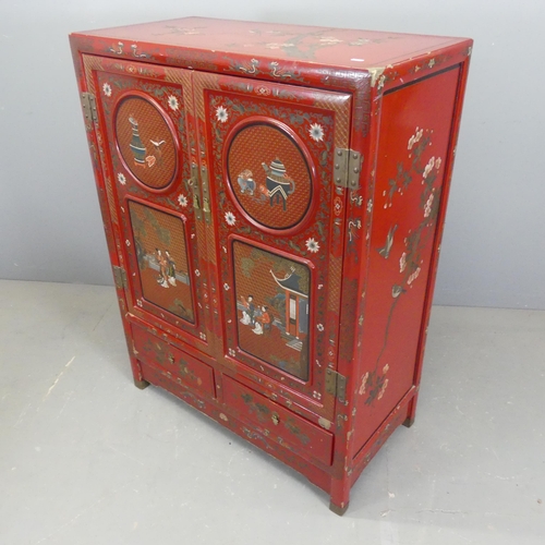 2706 - An early 20th century Chinese red-lacquered cabinet, with hand painted decoration, two doors reveali... 