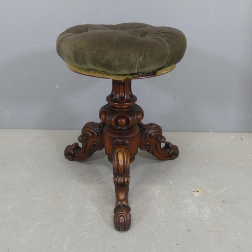 2710 - A Victorian carved walnut and upholstered piano stool. Seat diameter 38cm, height 49cm.