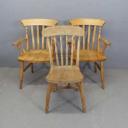 2717 - A pair of pine stick-back elbow chairs, and a similar dining chair. (3)