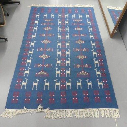 2305 - A blue-ground Tunisian Kilim rug. Length 184cm, width 113cm