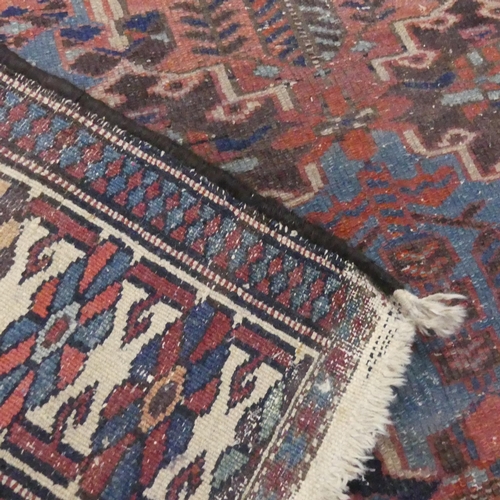 2306 - A red and blue-ground Persian rug. Length 200cm, width 140cm.