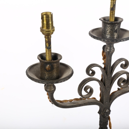 810 - An early 20th century Cotswold School iron candelabrum, adapted for electricity, H46cm