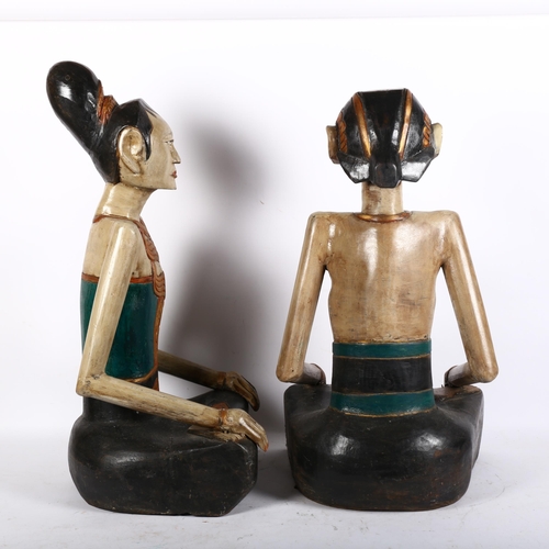 815 - A pair of modern carved wood seated Thai figures, unsigned, H65cm (2)