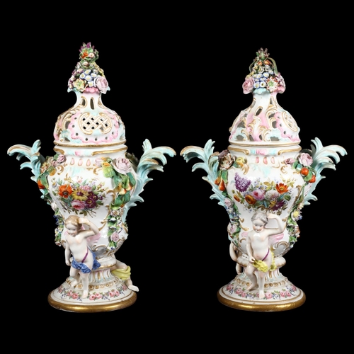 817 - A pair of German factory porcelain urns, with associated covers, with relief floral and cherub decor... 