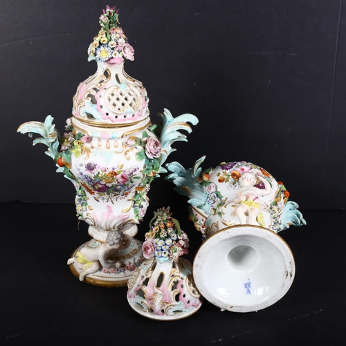 817 - A pair of German factory porcelain urns, with associated covers, with relief floral and cherub decor... 