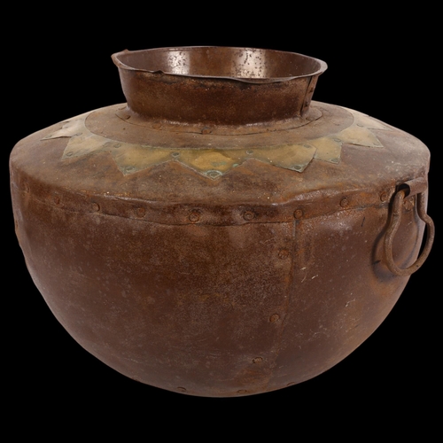 820 - A panelled steel pot with ring handles and brass decoration, 37cm across