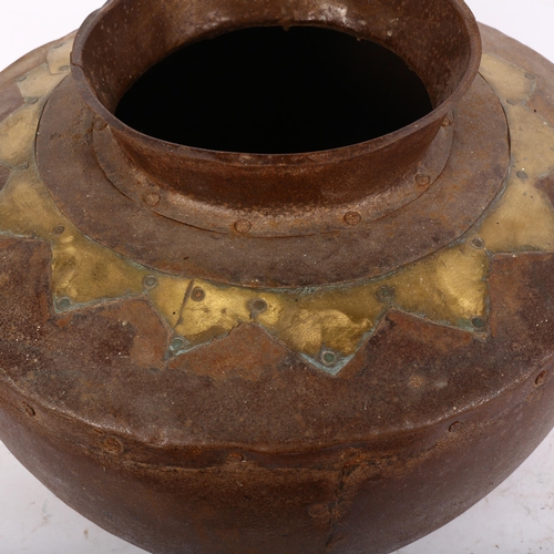 820 - A panelled steel pot with ring handles and brass decoration, 37cm across