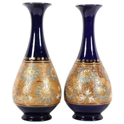 859 - A pair of Royal Doulton cobalt blue ground and gilded vases, H28cm