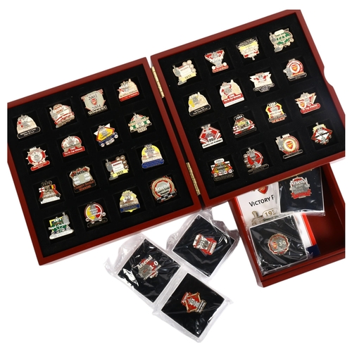 867 - A cased Arsenal FC Victory pin collection, comprising 32 enamelled pin badges plus 5 Community Shiel... 