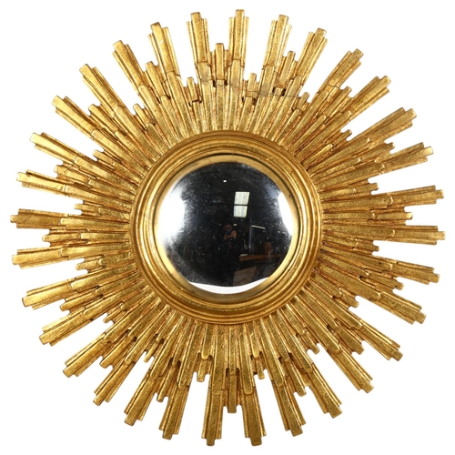 913 - A decorative sunburst wall mirror, with stylish convex glass, overall diameter approx 56cm