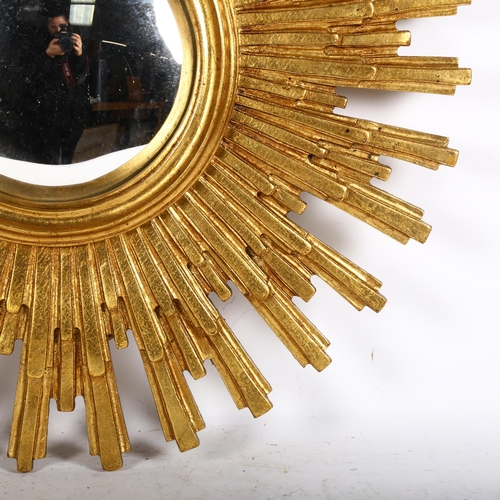 913 - A decorative sunburst wall mirror, with stylish convex glass, overall diameter approx 56cm