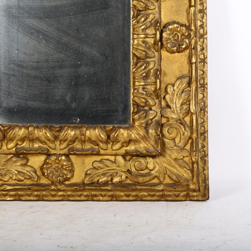 915 - An Antique giltwood wall-hanging mirror, with ornate floral border decoration, overall 62cm x 53cm