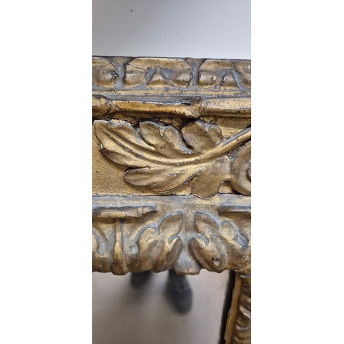 915 - An Antique giltwood wall-hanging mirror, with ornate floral border decoration, overall 62cm x 53cm