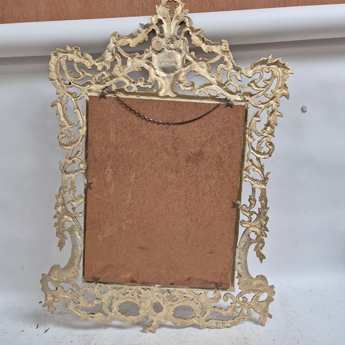 303 - An ornate gilt-metal framed wall mirror, overall 91cm x 63cm