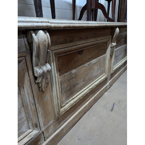 2163 - A Victorian pine pine shop counter, with panelled front and shelved reverse. Length 293cm, height 78... 