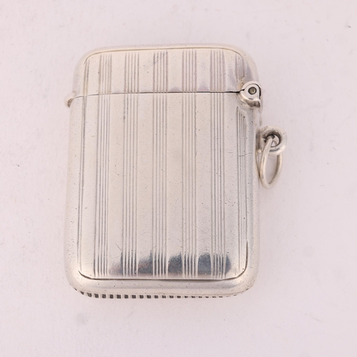 132 - An Edwardian silver Vesta case, Henry Matthews, Birmingham 1906, rounded rectangular form with reede... 