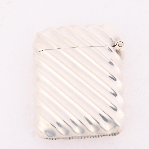 156 - An Edwardian silver Vesta case, Henry Matthews, Birmingham 1905, rectangular form with allover flute... 