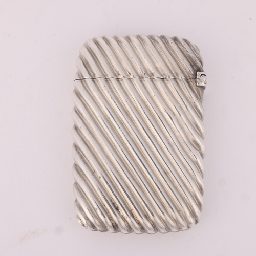 17 - SAMPSON MORDAN & CO - a Victorian silver Vesta case, London 1887, rectangular form with fluted decor... 