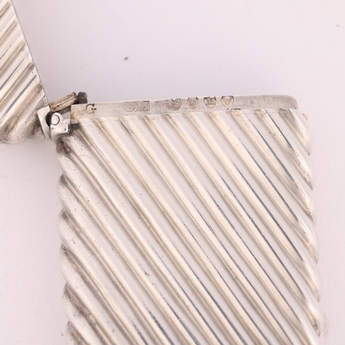 17 - SAMPSON MORDAN & CO - a Victorian silver Vesta case, London 1887, rectangular form with fluted decor... 