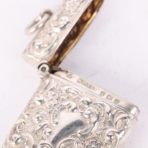 191 - An Edwardian silver Vesta case, AW Gamage Ltd, Birmingham 1905, rectangular form with allover relief... 