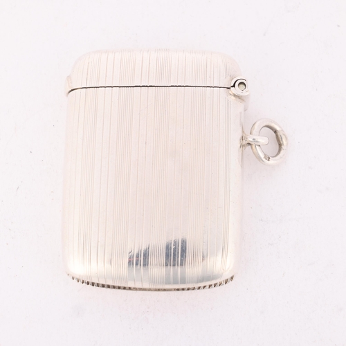 203 - An Edwardian silver Vesta case, William Neale & Sons, Chester 1908, rectangular form with allover en... 