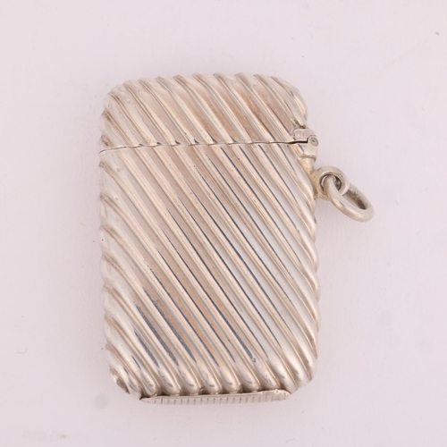 24 - SAMPSON MORDAN & CO - a Victorian silver Vesta case, London 1886, rectangular form with allover flut... 